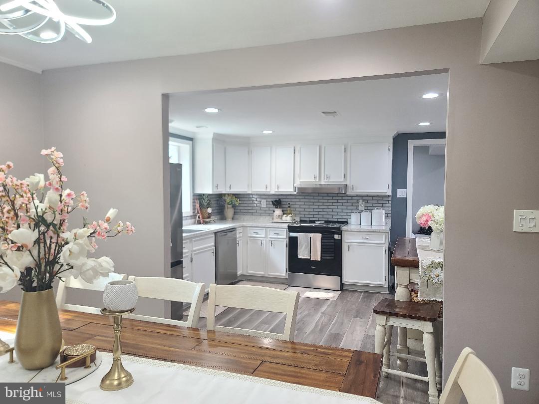 7834 Citadel Drive Severn, MD 21144 - Photo 41 of 58 a kitchen with granite countertop white cabinets and stainless steel appliances