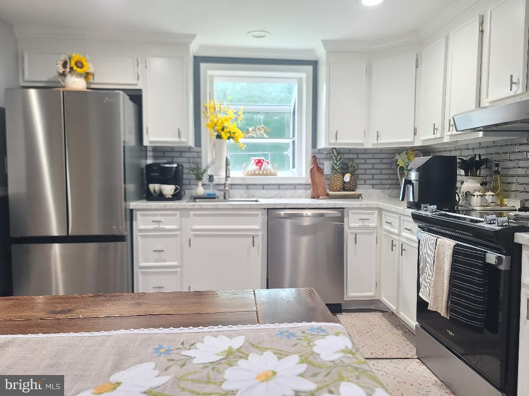 7834 Citadel Drive Severn, MD 21144 - Photo 43 of 58 a kitchen with a refrigerator sink and stove