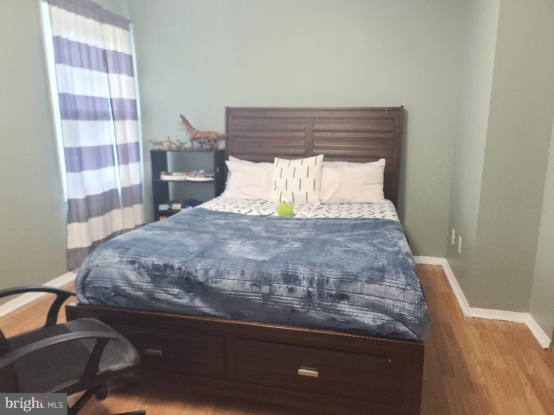 7834 Citadel Drive Severn, MD 21144 - Photo 45 of 58 a bed sitting in a bedroom next to a cabinet