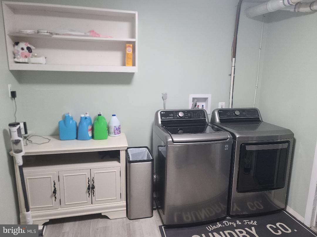 7834 Citadel Drive Severn, MD 21144 - Photo 52 of 58 a view of cabinets with washer and dryer