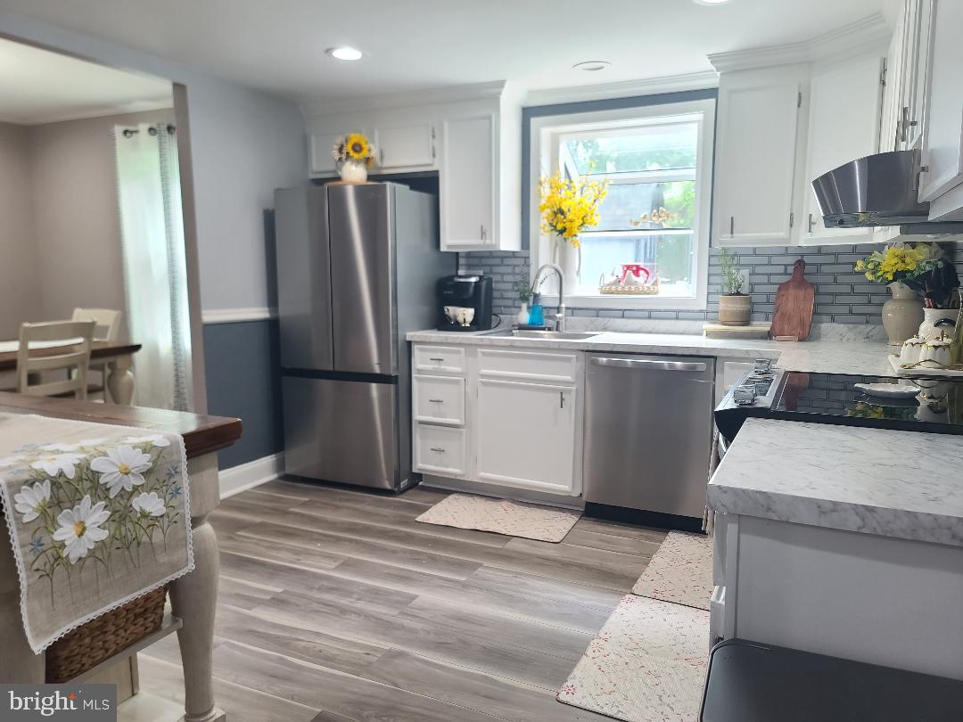 7834 Citadel Drive Severn, MD 21144 - Photo 10 of 58 a kitchen with a refrigerator and a sink