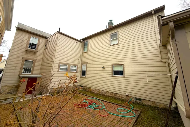 a view of a house with backyard and sitting area
