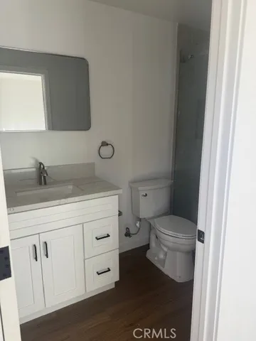 a bathroom with a sink a toilet a vanity and mirror