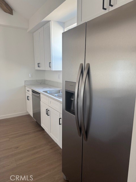 425 West Lime Avenue, Unit 1 Monrovia, CA 91016 - Photo 3 of 31 a kitchen with stainless steel appliances granite countertop a refrigerator a sink a stove and white cabinets with wooden floor