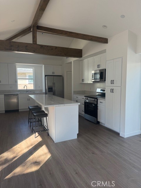 425 West Lime Avenue, Unit 1 Monrovia, CA 91016 - Photo 4 of 31 a kitchen with stainless steel appliances a stove a sink dishwasher a refrigerator and a dining table with wooden floor