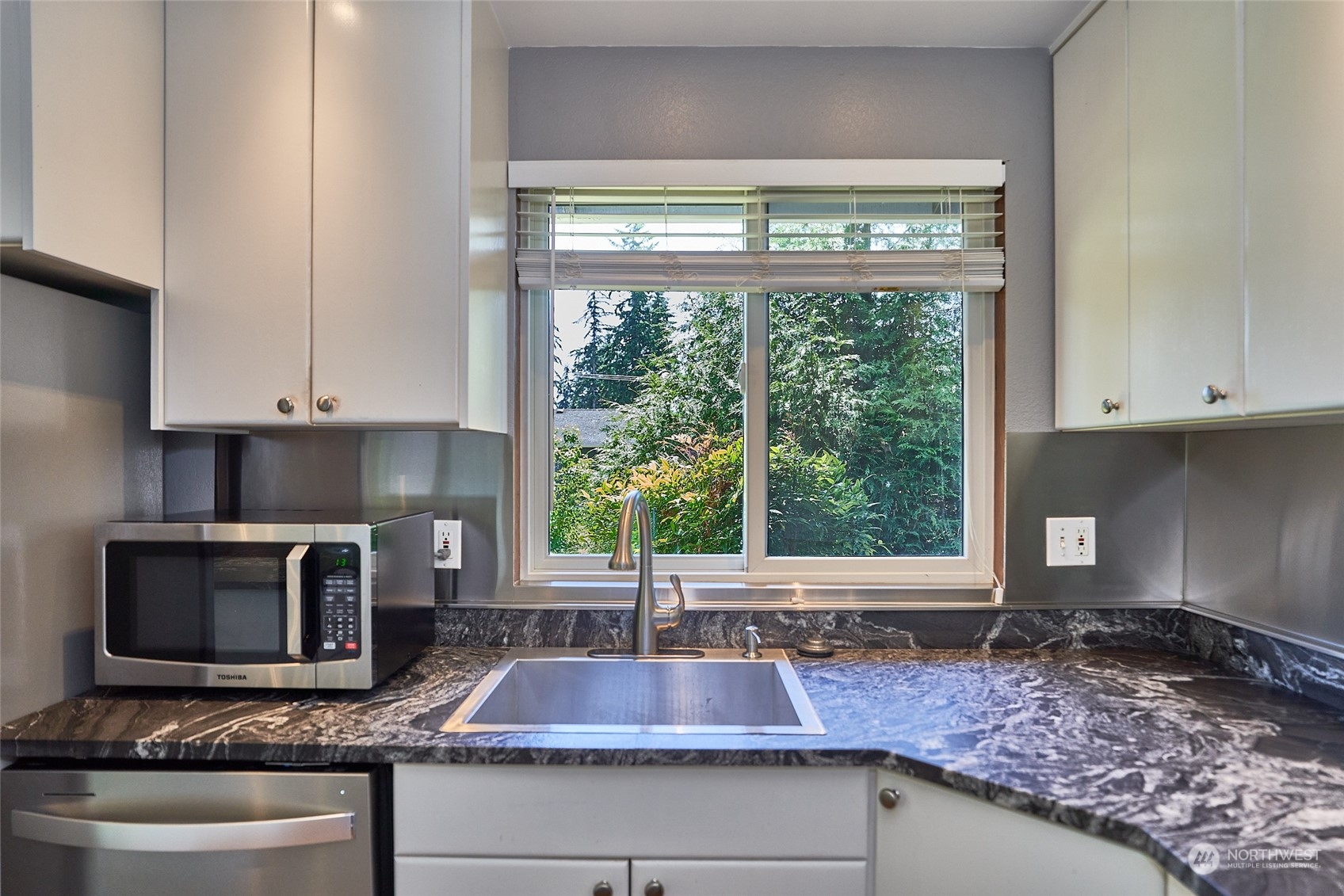 21518 1st Avenue West Bothell, WA 98021 - Photo 6 of 31 a kitchen with a stove a sink and a counter space