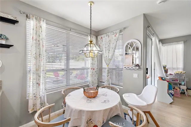 a dining room with furniture a chandelier and window
