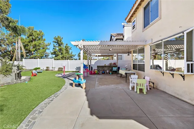 a view of a backyard with sitting area and slide