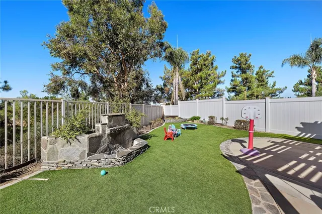 a view of a house with a backyard and sitting area