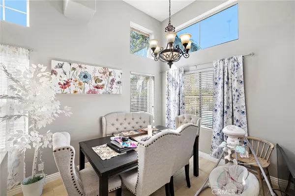 a view of a dining room with furniture wooden floor and chandelier