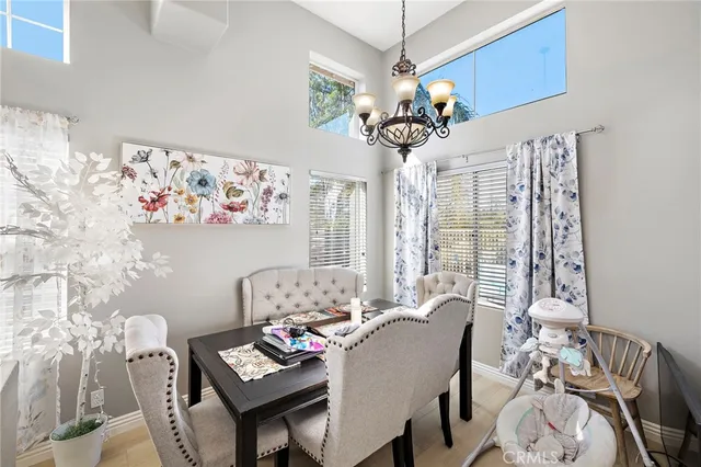 a view of a dining room with furniture wooden floor and chandelier