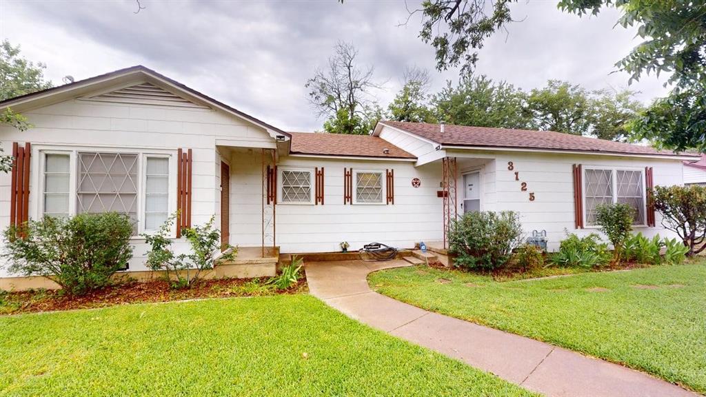 Single story home featuring a front lawn