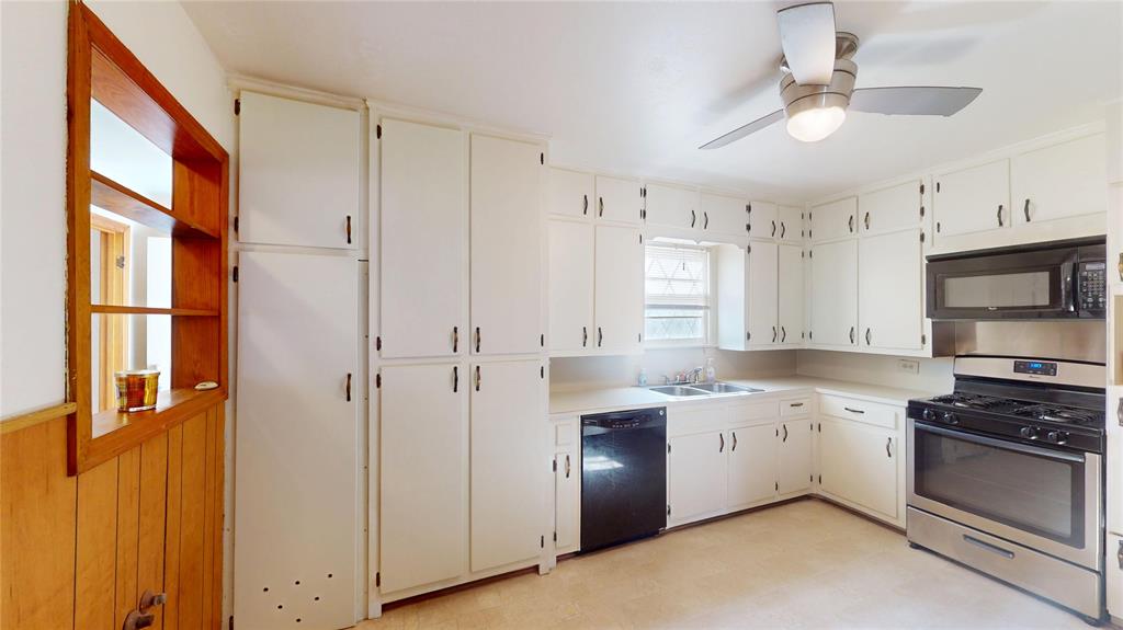 3125 McFerrin Avenue Waco, TX 76708 - Photo 16 of 36 Kitchen with black appliances, light countertops, light floors, ceiling fan, and white cabinets