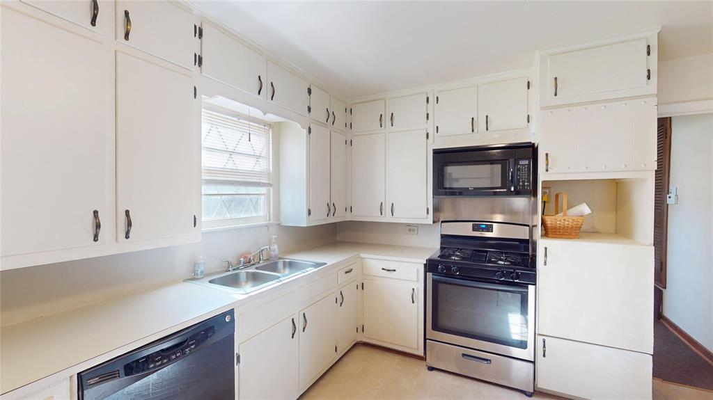 3125 McFerrin Avenue Waco, TX 76708 - Photo 17 of 36 Kitchen featuring appliances with stainless steel finishes, light countertops, and white cabinetry