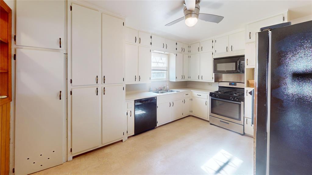 3125 McFerrin Avenue Waco, TX 76708 - Photo 18 of 36 Kitchen featuring black appliances, light flooring, light countertops, ceiling fan, and white cabinetry