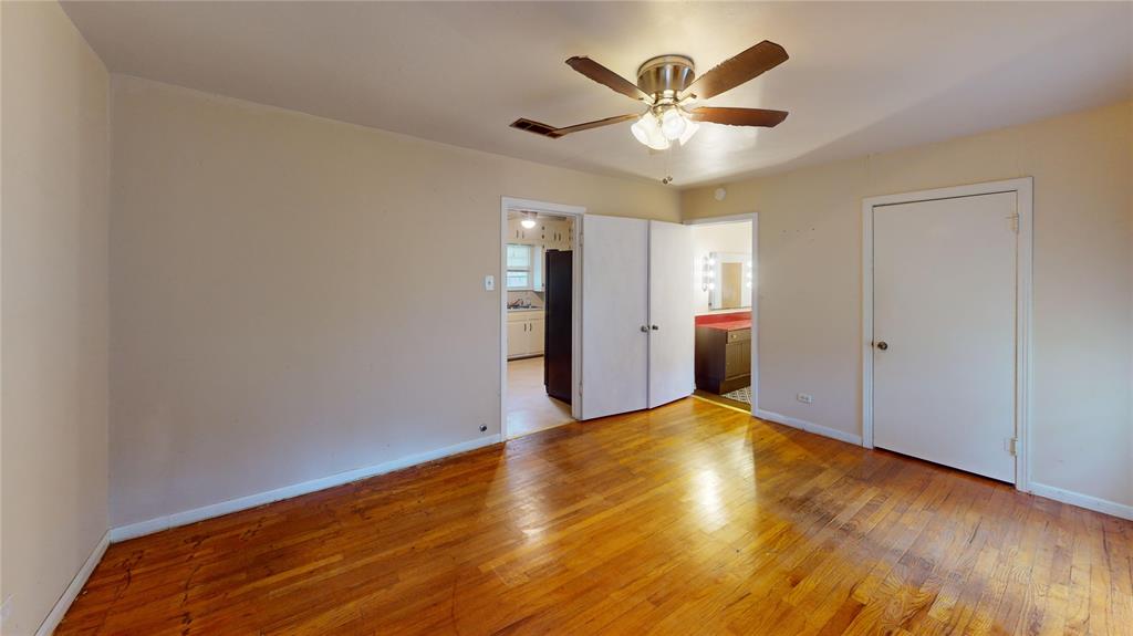 3125 McFerrin Avenue Waco, TX 76708 - Photo 19 of 36 Unfurnished bedroom with light wood finished floors, a ceiling fan, and connected bathroom