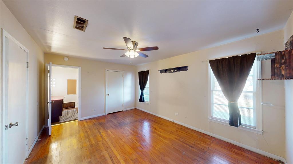 3125 McFerrin Avenue Waco, TX 76708 - Photo 22 of 36 Unfurnished bedroom featuring wood-type flooring, ceiling fan, and connected bathroom