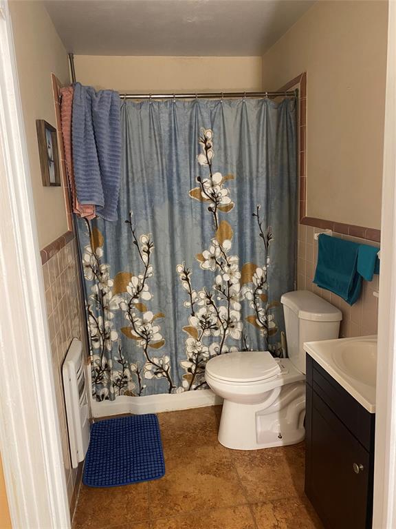 3125 McFerrin Avenue Waco, TX 76708 - Photo 23 of 36 Full bath with tile walls, vanity, wainscoting, and heating unit