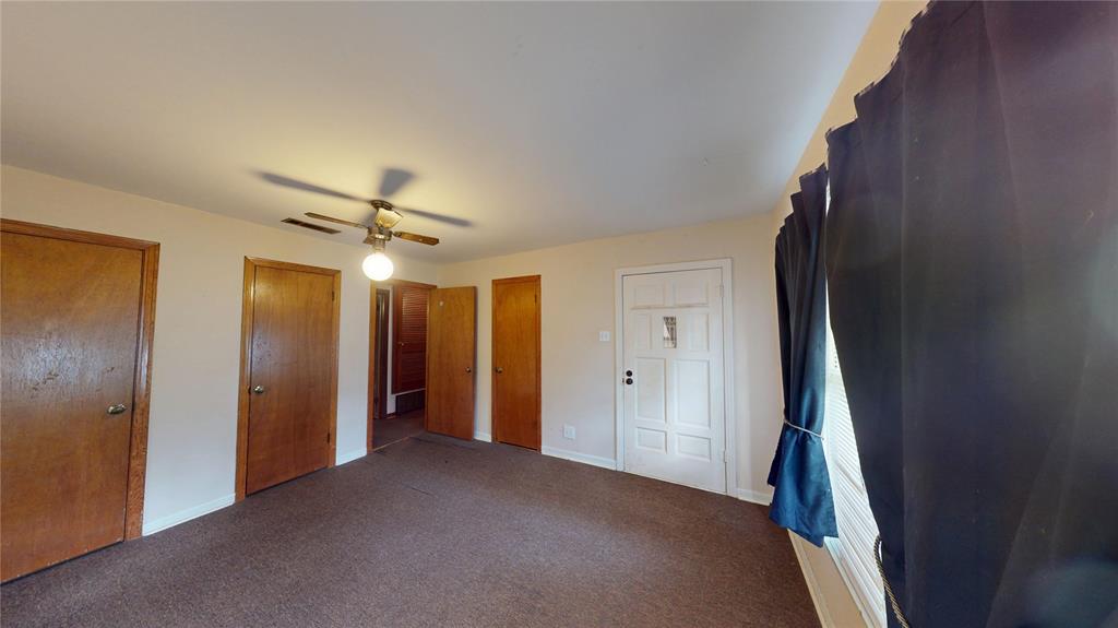 3125 McFerrin Avenue Waco, TX 76708 - Photo 30 of 36 Unfurnished bedroom featuring multiple closets, carpet, and a ceiling fan
