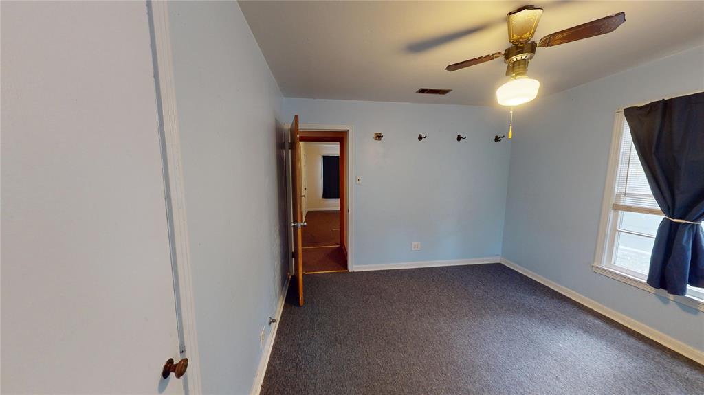 3125 McFerrin Avenue Waco, TX 76708 - Photo 32 of 36 Spare room with dark colored carpet and ceiling fan