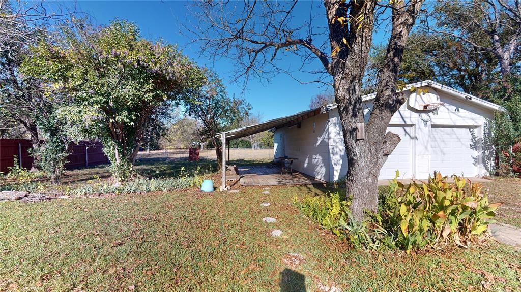 3125 McFerrin Avenue Waco, TX 76708 - Photo 5 of 36 View of side of home with concrete block siding and a garage
