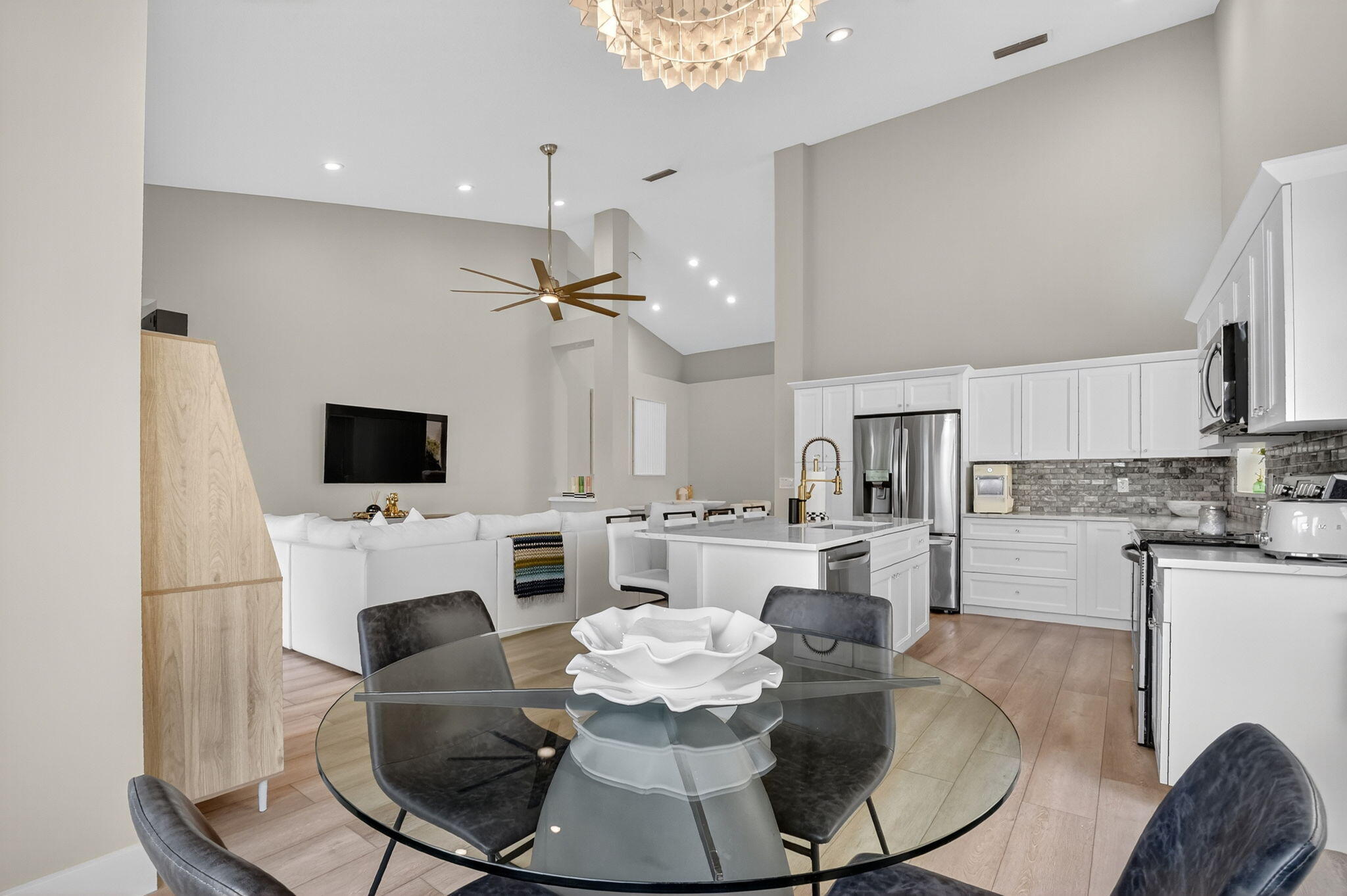 8385 Horseshoe Bay Road Boynton Beach, FL 33472 - Photo 14 of 49 a dining room with furniture a fireplace and a flat screen tv