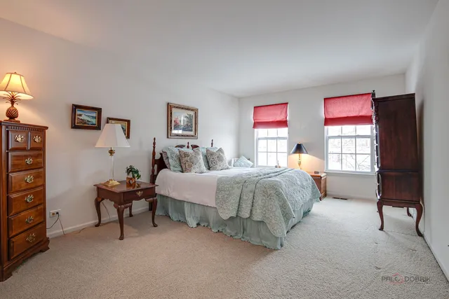 a spacious bedroom with a bed and a window