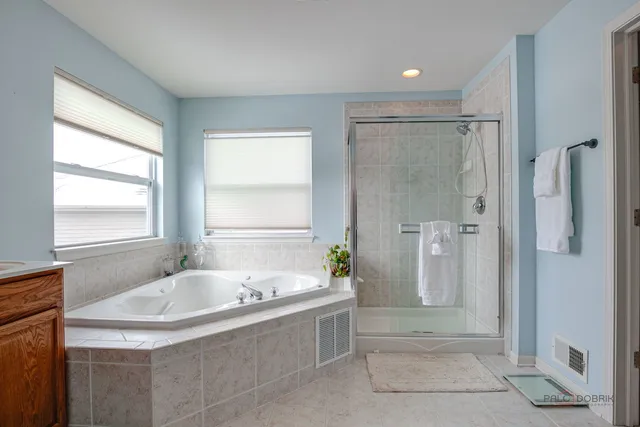 a bathroom with a tub and shower