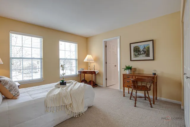 a spacious bedroom with a bed and a table