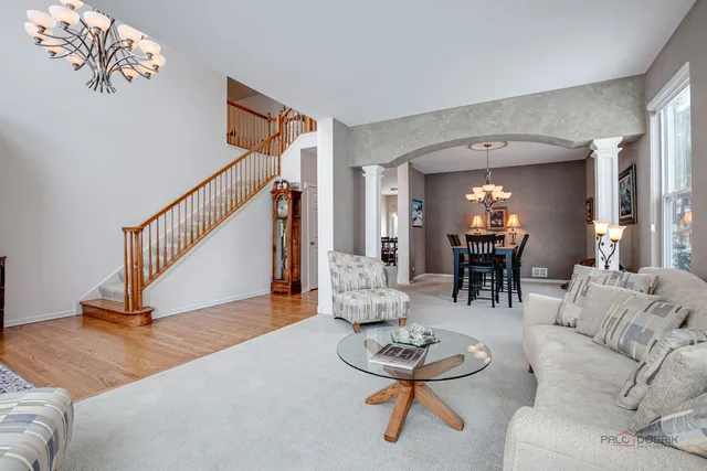 a living room with furniture and a dining table with kitchen view