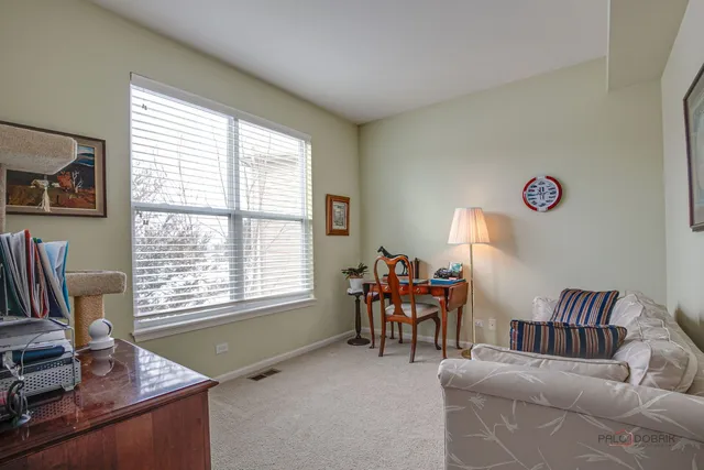 a livingroom with workspace and a window