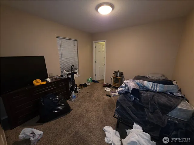 a bed room with a bed and a television