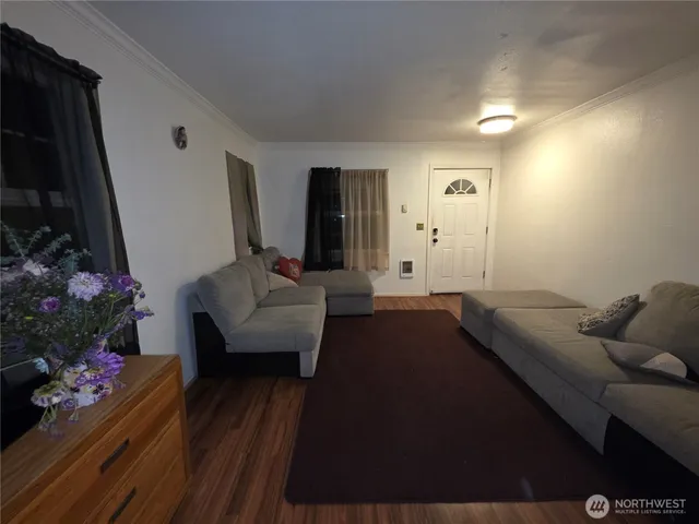 a living room with furniture and flowers