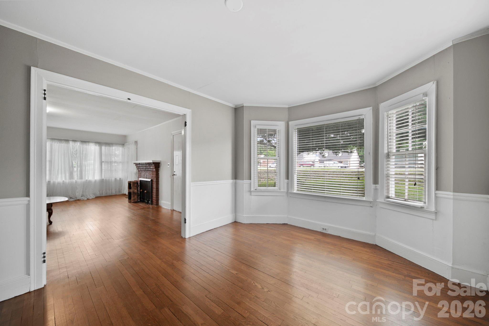 1109 Union Road Gastonia, NC 28054 - Photo 8 of 44 an empty room with wooden floor and windows