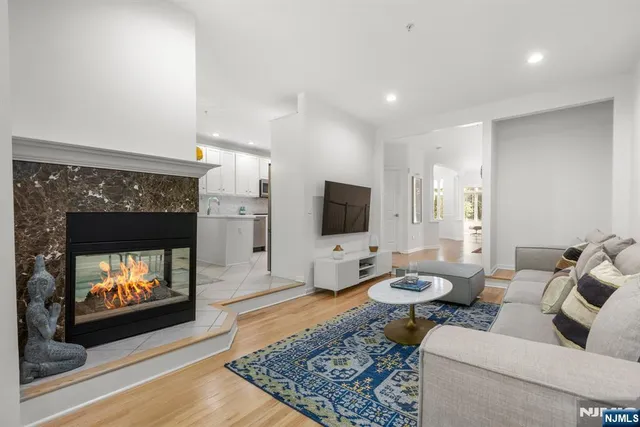 a view of a dining room with furniture a chandelier and wooden floor
