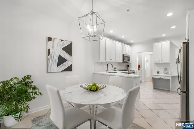 a living room with furniture a fireplace and a chandelier