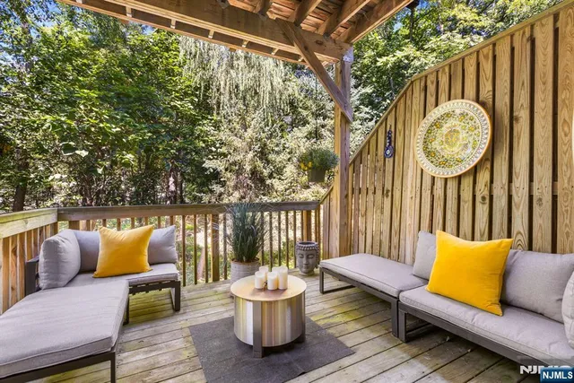 a living room with furniture wooden floor and a flat screen tv