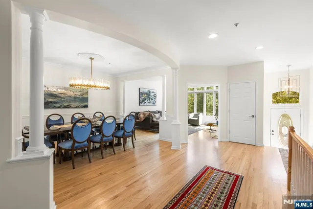 a living room with furniture and a dining table