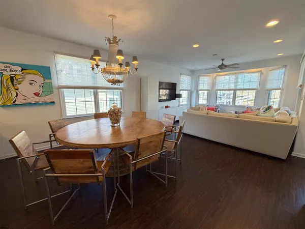 a dining room with furniture a window and wooden floor