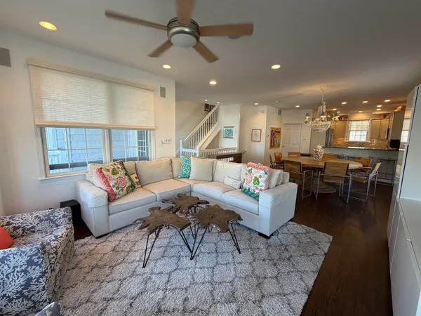 a living room with furniture and kitchen view