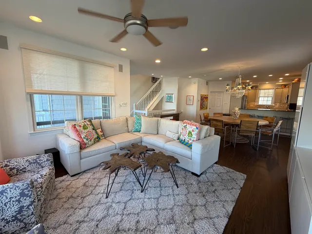 a living room with furniture and kitchen view