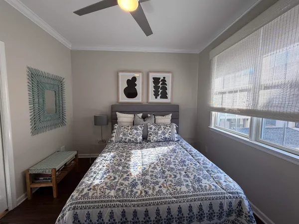 a bed sitting in a bedroom next to a window