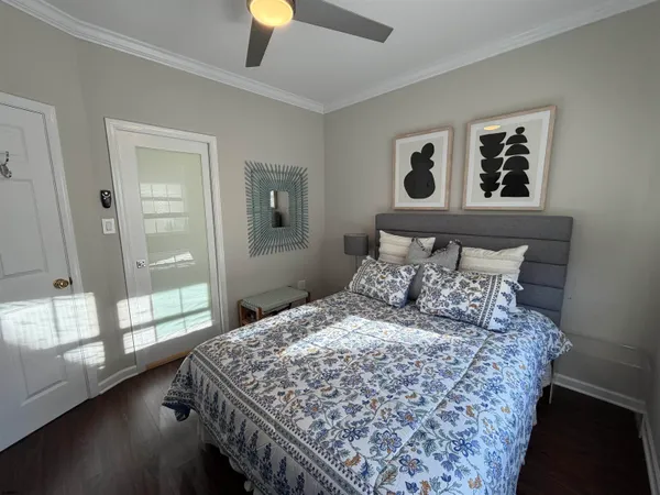 a large bed sitting in a bedroom next to a window