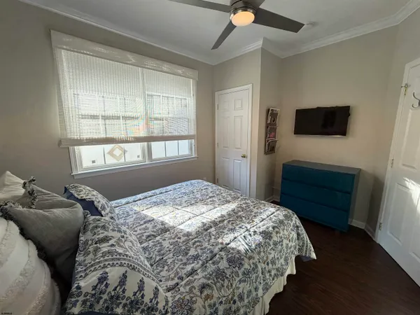 a bedroom with a bed and a television