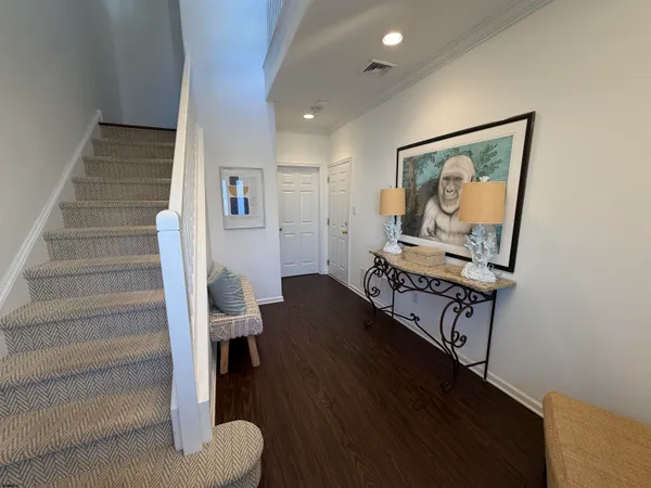 a hallway with wooden floor and furniture