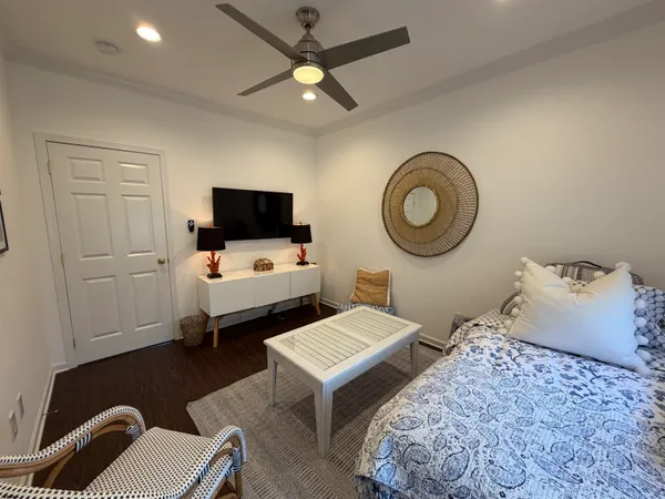 a bedroom with bed and a flat screen tv