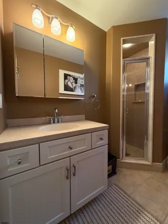 a bathroom with a sink mirror and vanity