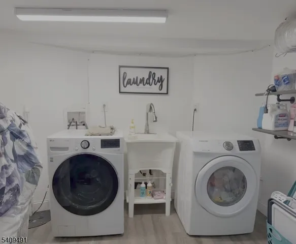 a utility room with sink dryer and washer