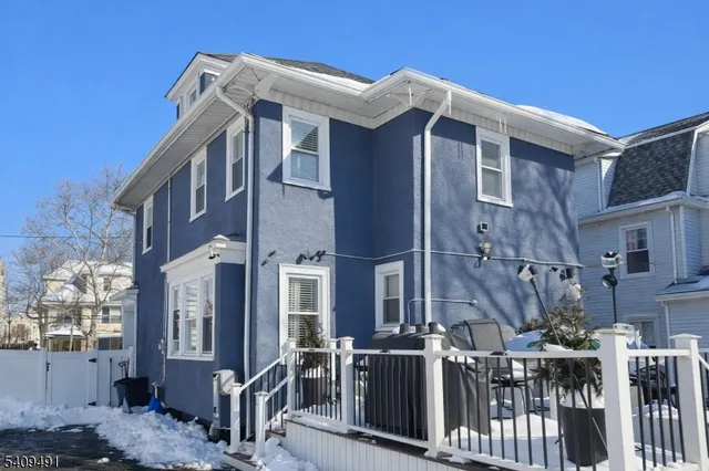 a front view of a house with iron fence