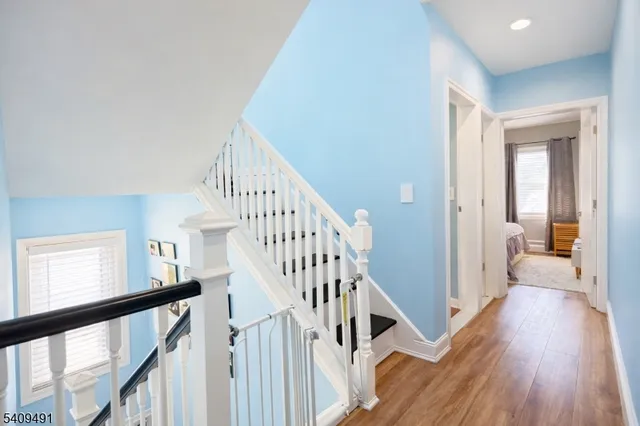 a view of a hallway view with wooden floor and staircase